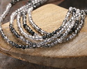 Tourmalinated Quartz (A) Ombré Micrfaceted Round 2mm